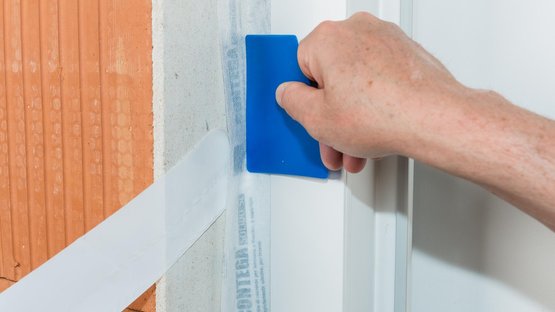 6. Stick the tape to the reveal all around the frame and rub to secure